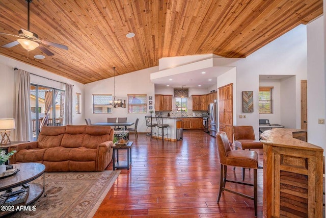 living room featuring plenty of natural light, ceiling fan with notable chandelier, dark hardwood / wood-style floors, and wood ceiling