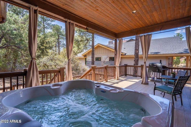 view of pool featuring an outdoor hot tub and a deck