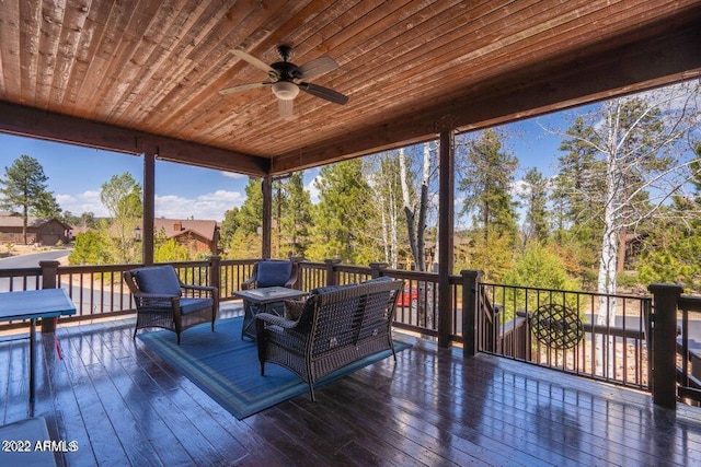 wooden deck featuring ceiling fan