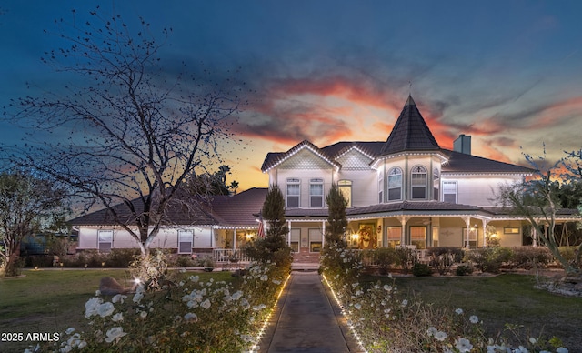 victorian-style house featuring a yard