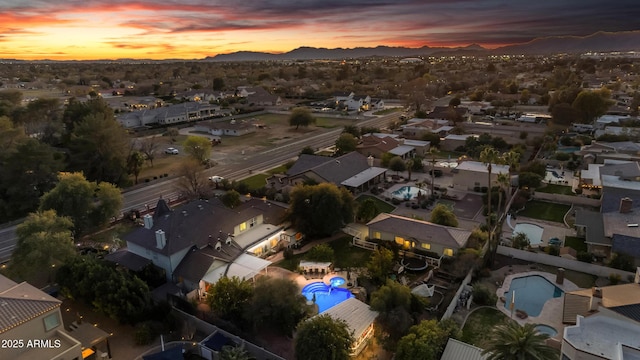 aerial view at dusk featuring a mountain view