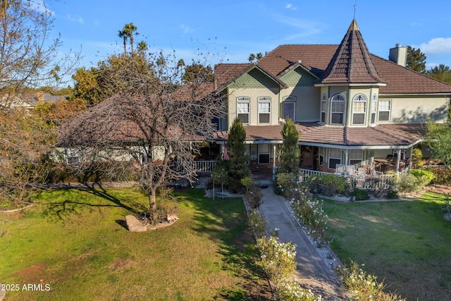 victorian-style house with a porch and a front yard