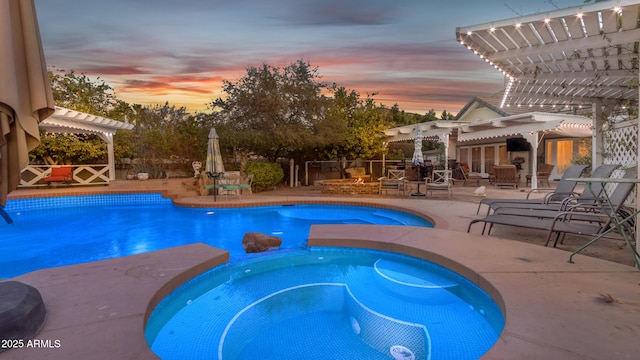 pool at dusk with a pergola, a patio, and an in ground hot tub