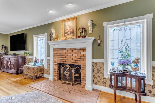 living room featuring hardwood / wood-style floors, crown molding, and a fireplace