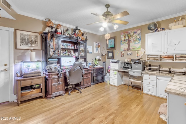 home office featuring ceiling fan, ornamental molding, and light wood-type flooring