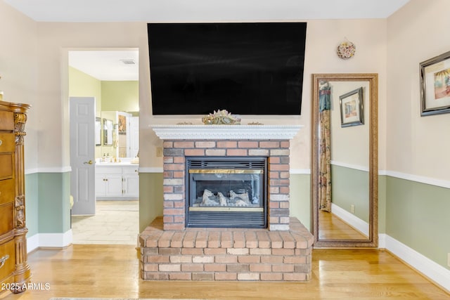 details with a fireplace and wood-type flooring