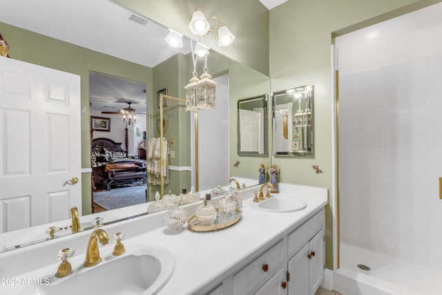 bathroom featuring vanity, ceiling fan, and a shower