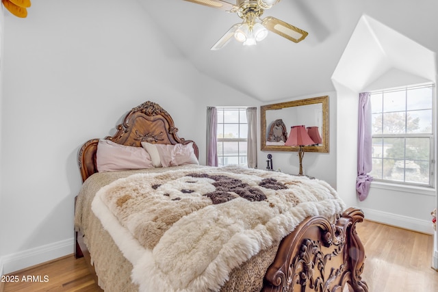 bedroom featuring vaulted ceiling, ceiling fan, and light wood-type flooring