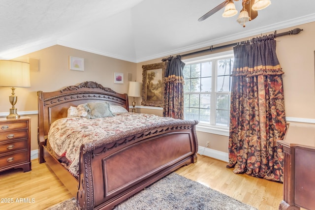 bedroom with crown molding, ceiling fan, lofted ceiling, and light hardwood / wood-style flooring