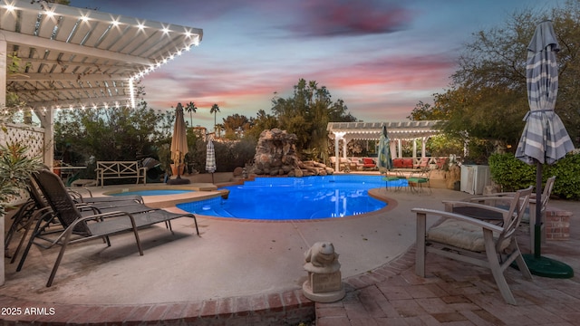 pool at dusk featuring an in ground hot tub, a pergola, and a patio