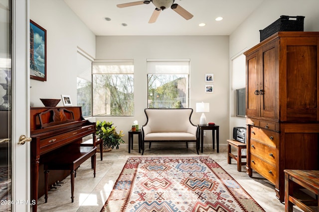 living area featuring light tile patterned flooring and ceiling fan