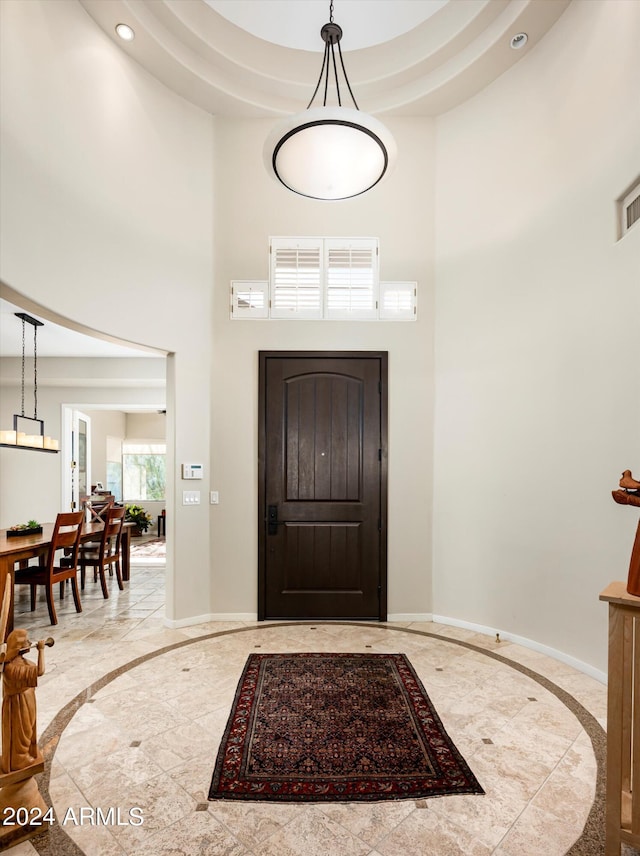 foyer featuring a towering ceiling