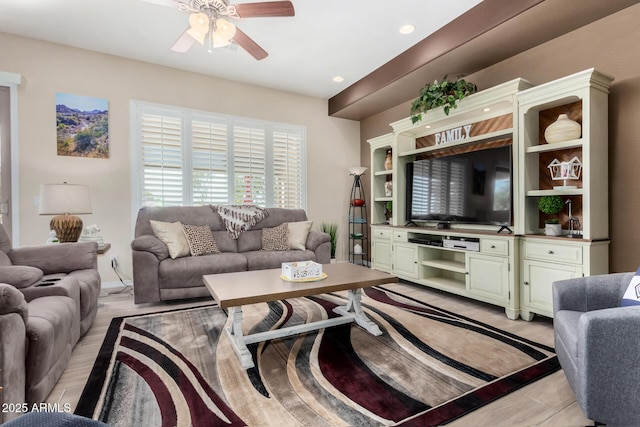 living room featuring ceiling fan and light hardwood / wood-style flooring