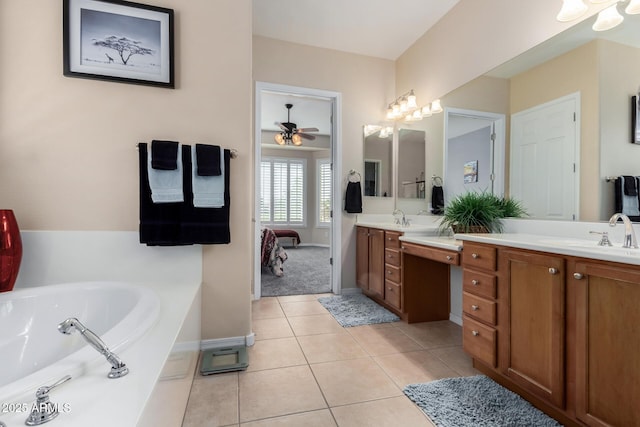 bathroom featuring ceiling fan, vanity, a bath, and tile patterned flooring