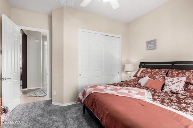 bedroom featuring ceiling fan, light carpet, and a closet