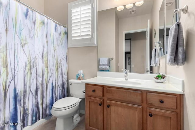 bathroom featuring tile patterned floors, vanity, and toilet