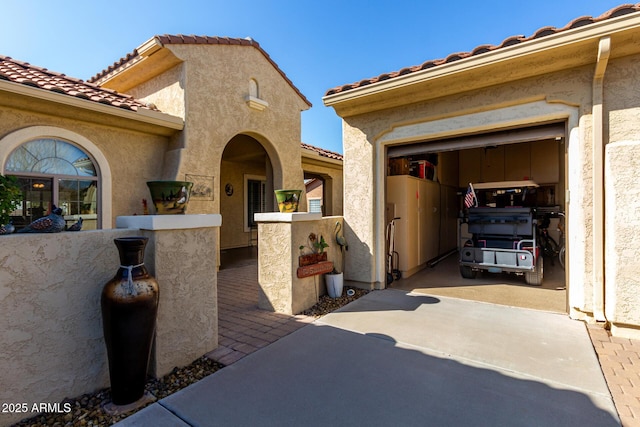 view of exterior entry featuring a garage