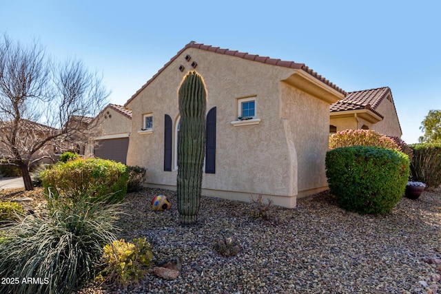 view of side of home with a garage