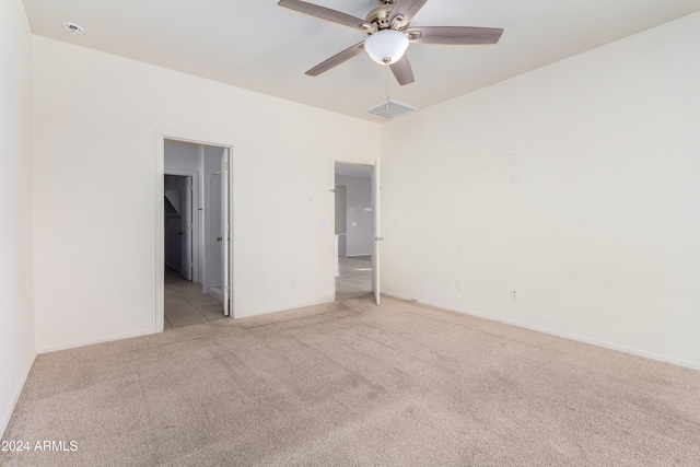 unfurnished bedroom featuring light colored carpet and ceiling fan