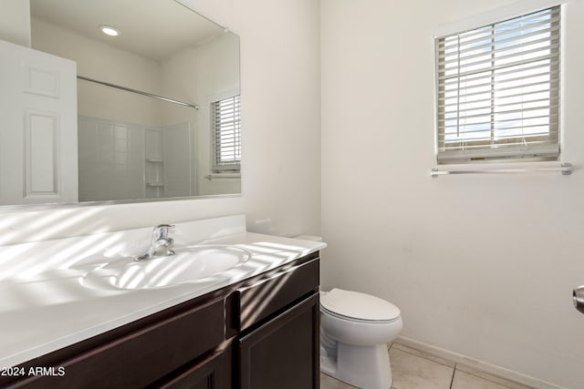 bathroom with walk in shower, tile patterned flooring, plenty of natural light, and vanity