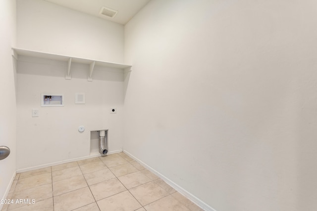 washroom featuring washer hookup, hookup for a gas dryer, light tile patterned flooring, and hookup for an electric dryer