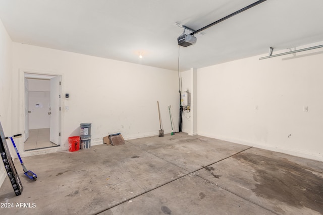 garage featuring water heater and a garage door opener