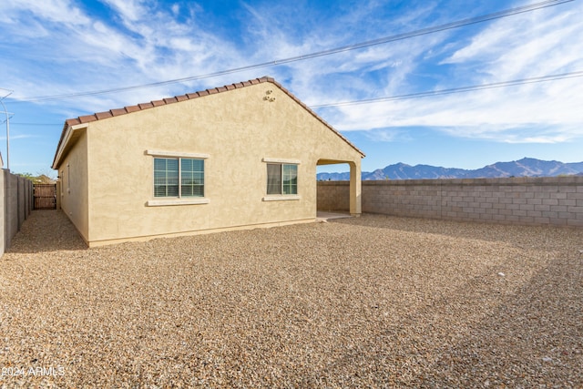 back of house with a mountain view