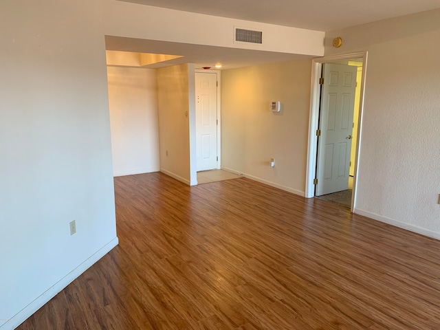 unfurnished room featuring dark hardwood / wood-style floors