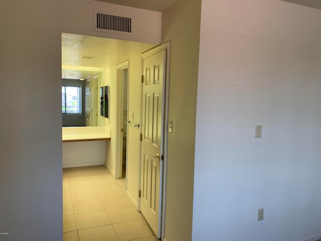 corridor featuring light tile patterned floors