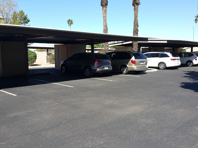 view of parking / parking lot featuring a carport