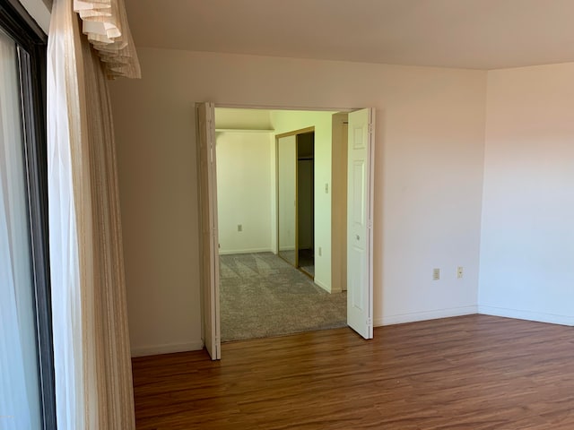 empty room featuring dark hardwood / wood-style flooring