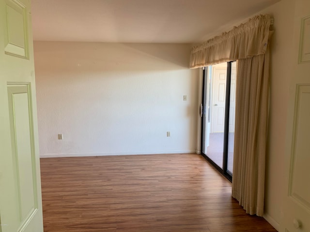 empty room with hardwood / wood-style flooring