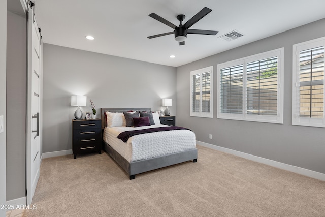 bedroom featuring baseboards, multiple windows, visible vents, and light colored carpet