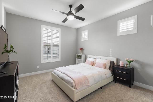 carpeted bedroom featuring ceiling fan and baseboards