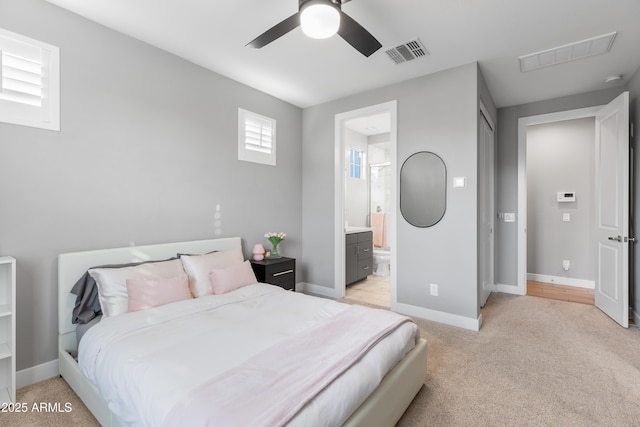 bedroom with baseboards, visible vents, and light colored carpet