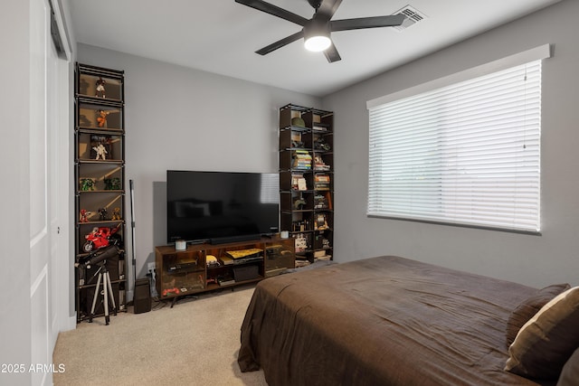 bedroom with carpet floors, visible vents, and ceiling fan