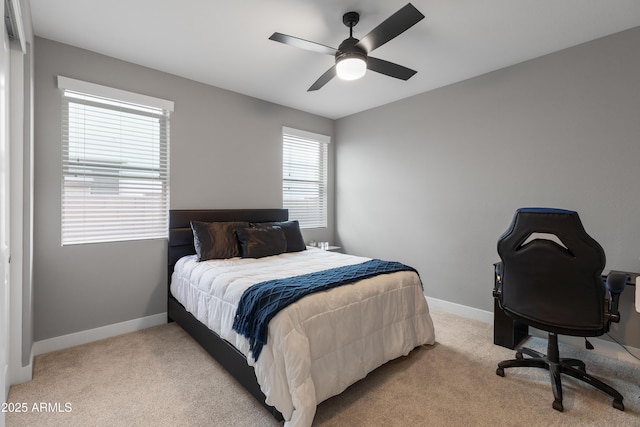 bedroom with light carpet, a ceiling fan, and baseboards