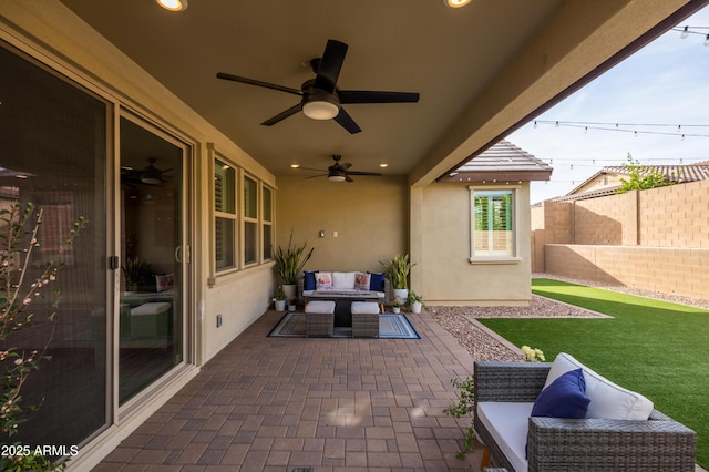 view of patio featuring ceiling fan, fence, and outdoor lounge area