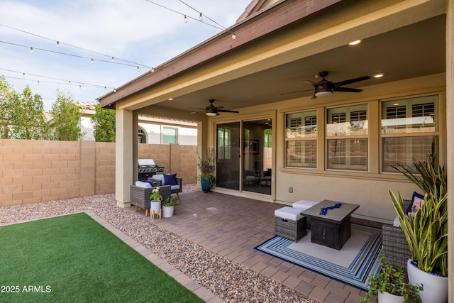 view of patio with fence and a ceiling fan