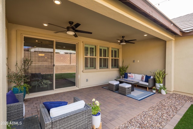 view of patio with a ceiling fan and an outdoor living space