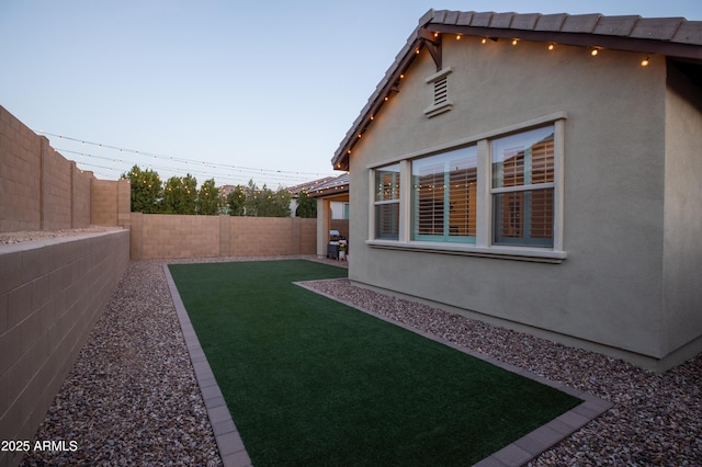 view of yard with a fenced backyard