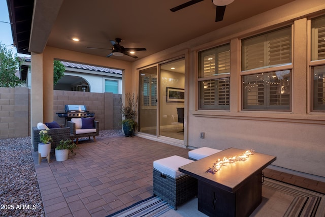 view of patio / terrace with a grill, fence, a fire pit, and ceiling fan