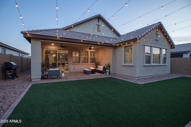 back of property featuring ceiling fan, fence private yard, a patio, and stucco siding