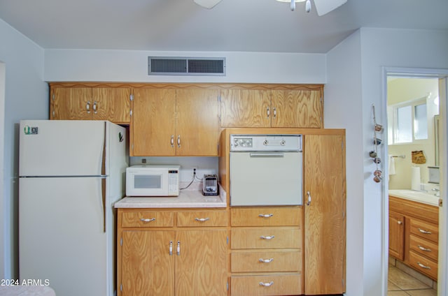 kitchen with ceiling fan, white appliances, sink, and light tile patterned floors