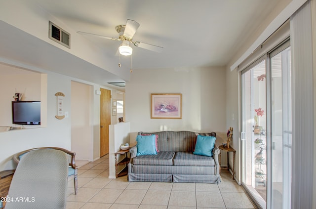 living room with ceiling fan and light tile patterned flooring