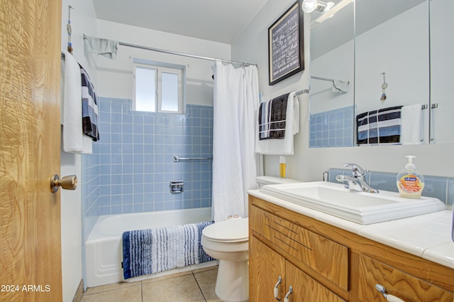 full bathroom featuring toilet, shower / bath combo, vanity, and tile patterned floors