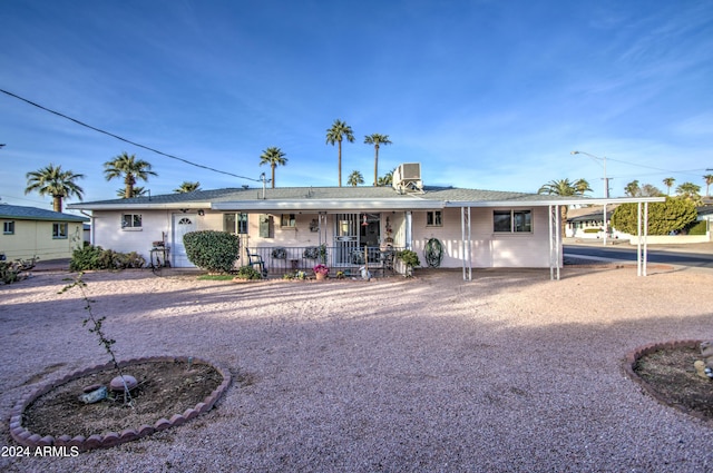 single story home featuring a carport and covered porch