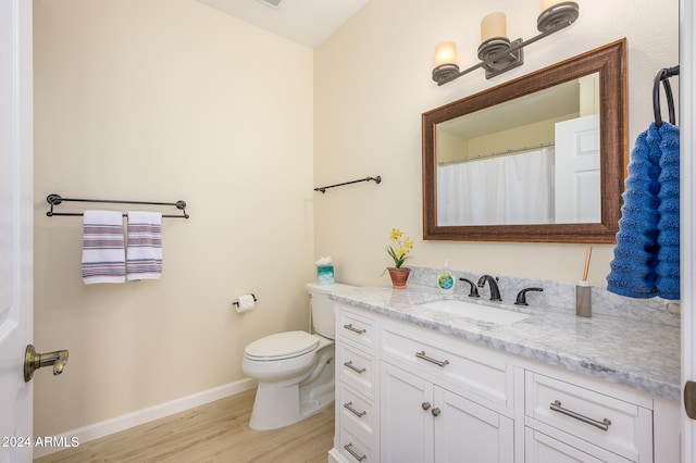 bathroom featuring hardwood / wood-style flooring, vanity, and toilet