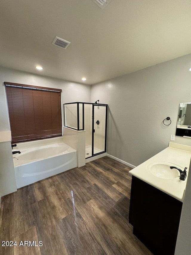 bathroom with vanity, plus walk in shower, and hardwood / wood-style flooring