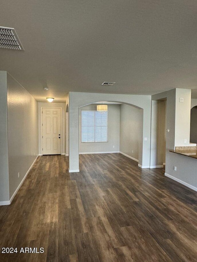 unfurnished living room with dark hardwood / wood-style flooring